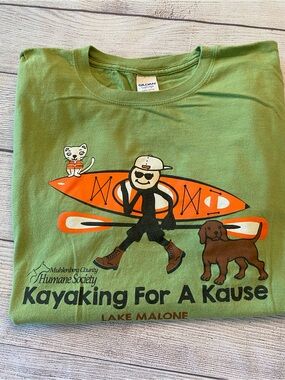 Green Graphic Tee with Orange Kayak, White Cat, and Brown Dog